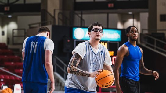 Robbie Avila (center), Kalu Anya (right)  & Killian Brockhoff (left) shoot around before a Saint Louis away game